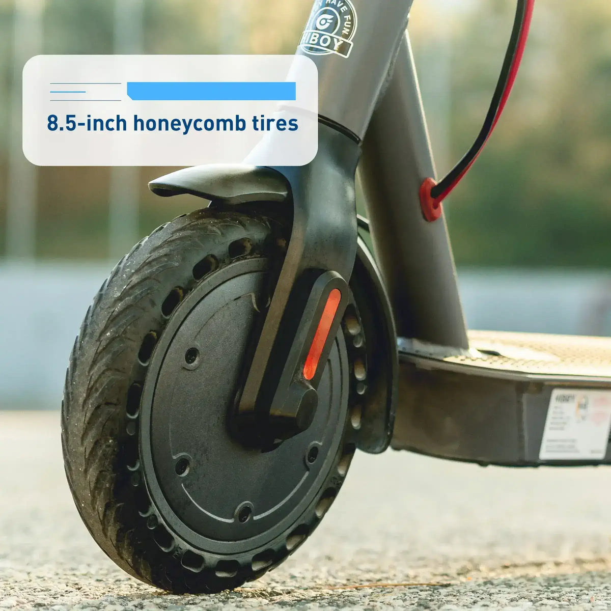 Electric scooter front wheel with 8.5-inch honeycomb tires on outdoor pavement