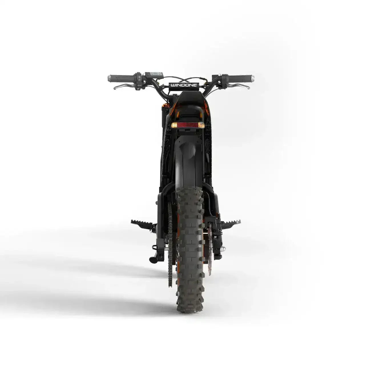 Rear view of off-road dirt bike with knobby tires and wide handlebars on white background