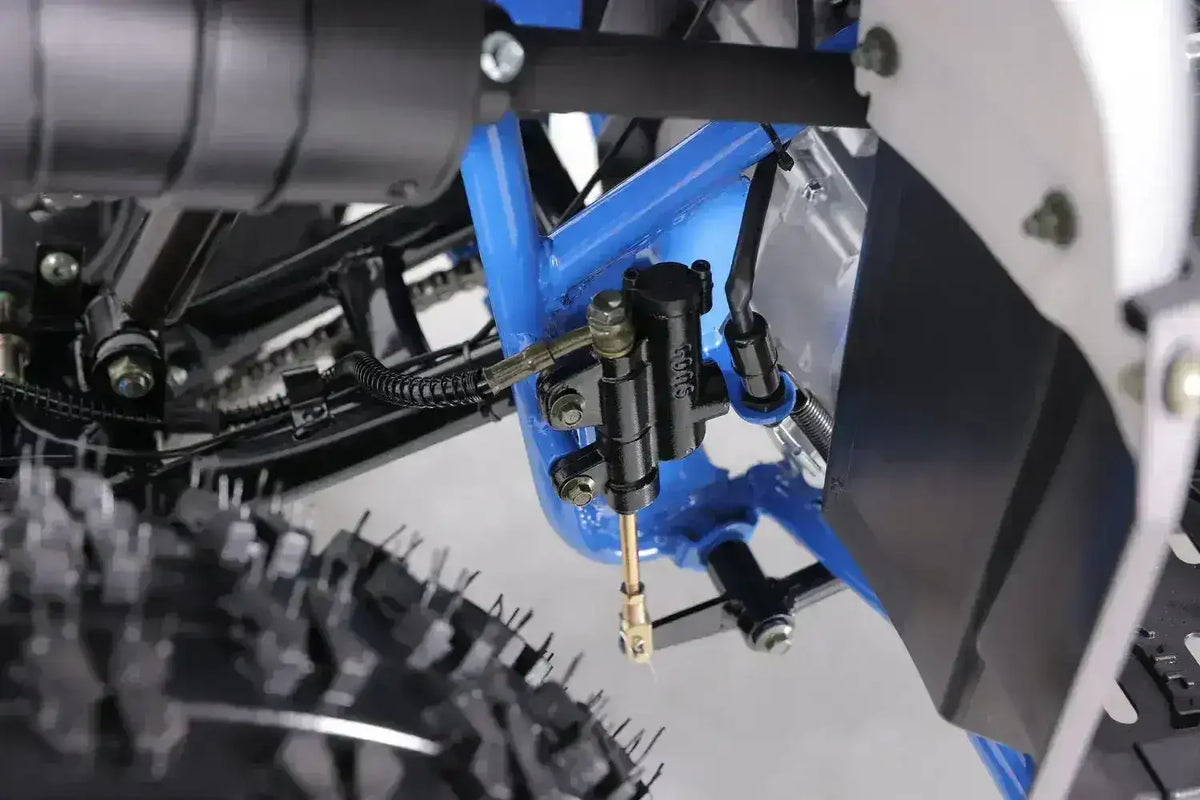 Close-up of rear ATV brake system and tire on blue Q9 PowerSports USA youth vehicle