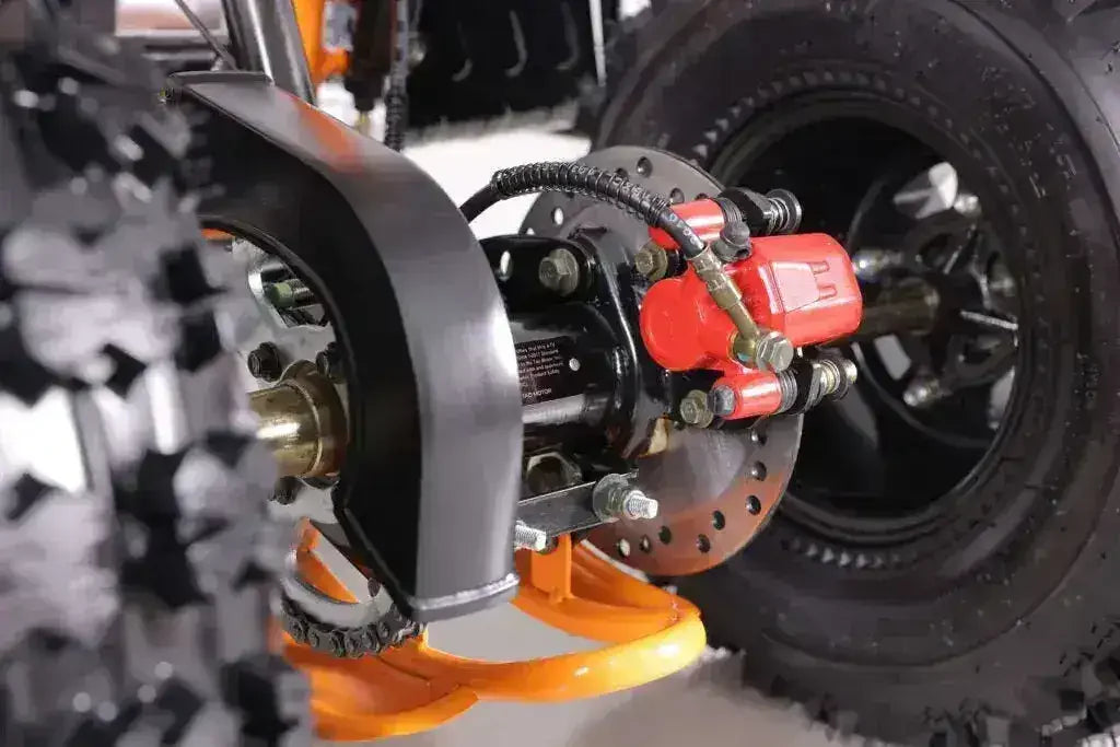 Close-up of ATV rear wheel, disc brake system, and off-road tire tread