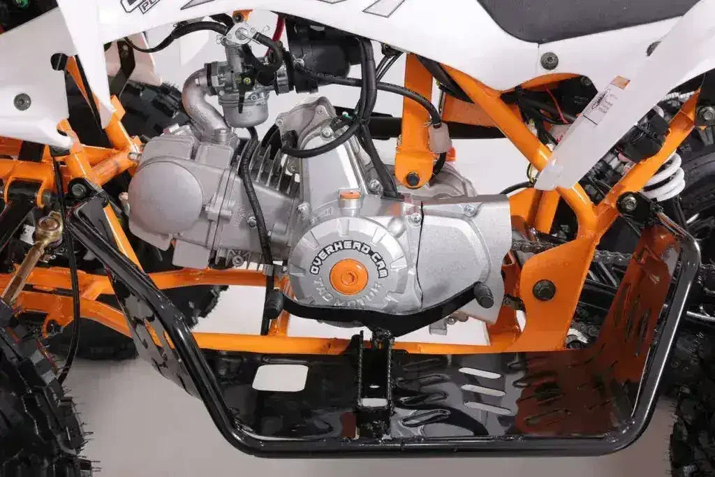 Close-up of ATV engine and orange frame with off-road tires