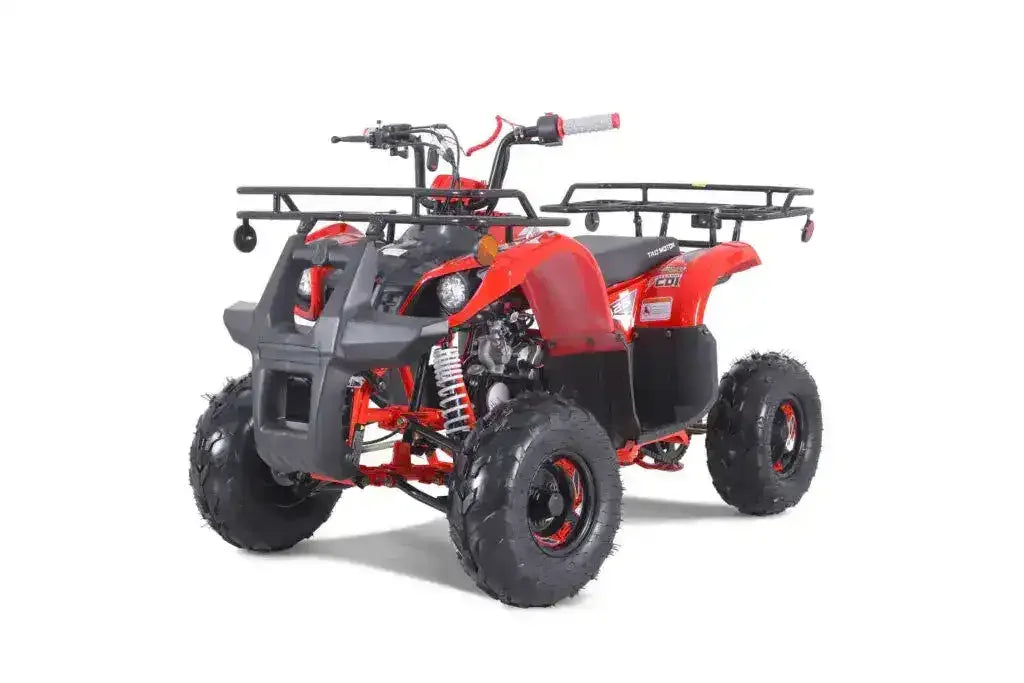 Red youth ATV with rugged tires and front rack on white background
