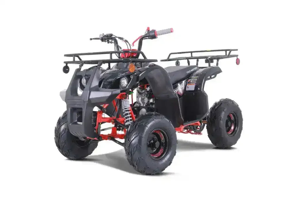 Black and red ATV with rugged tires and front rack, angled view on white background