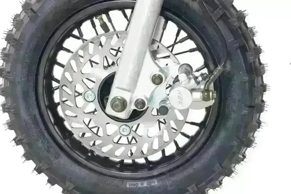 Close-up of dirt bike front wheel with knobby tire and disc brake, Q9 PowerSports USA