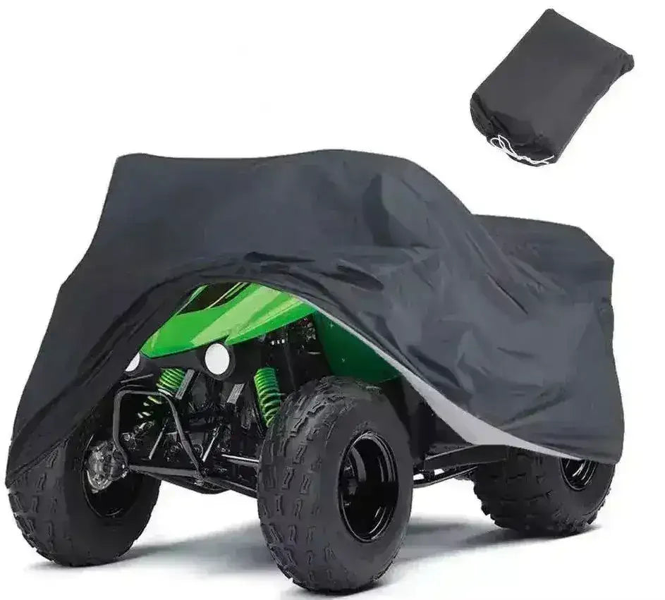 Green ATV partially covered with a black all-weather protective cover, storage bag shown