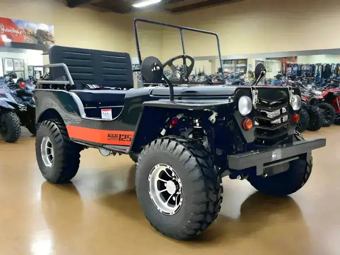 Black Willys-style Icebear go-kart with bench seat, windshield frame and round headlights on the showroom floor