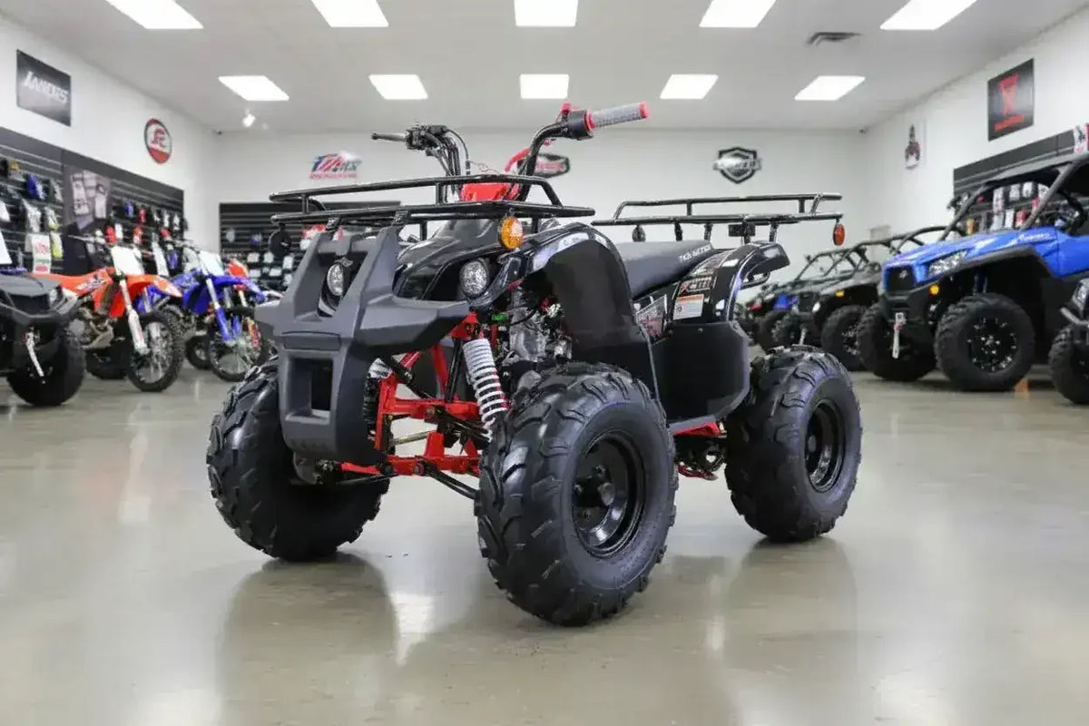 Black and red ATV on showroom floor with other off-road vehicles in background