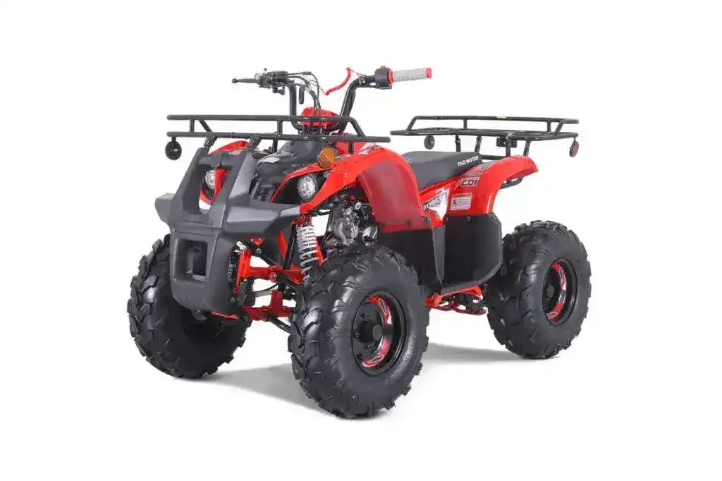 Red four-wheel ATV with rugged tires and front and rear cargo racks on a white background.