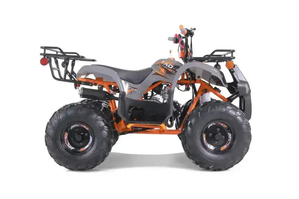 Side view of a dark gray and orange ATV with rugged tires, rear cargo rack, and off-road design