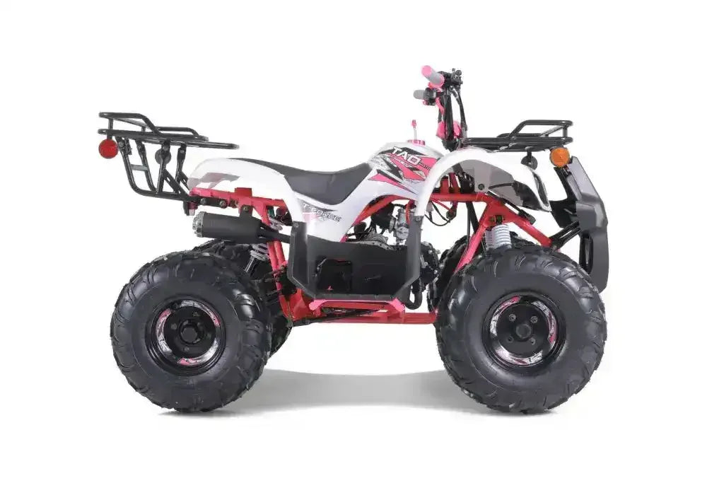 White and pink youth ATV with rugged tires, rear rack, and sporty frame side view