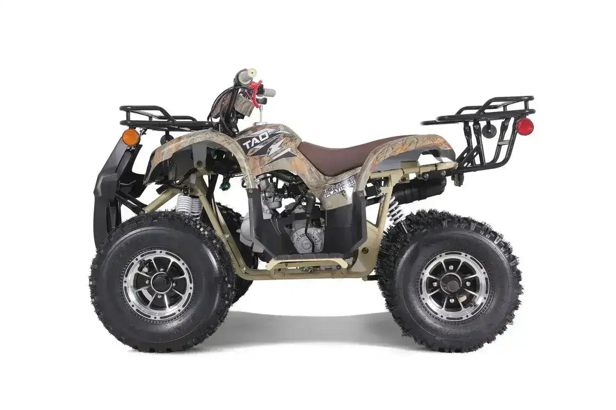 Camouflage youth ATV with rugged tires at Q9 PowerSports USA, side driver view