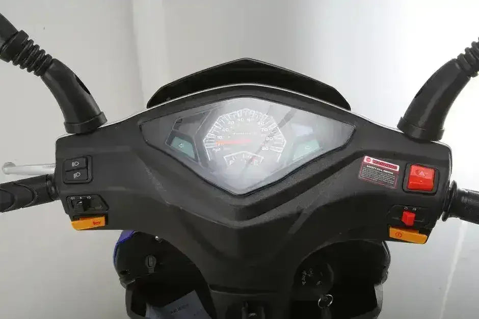 Rider's view of the RPS Adventure scooter analog speedometer, fuel gauge, handlebar switches and ignition key