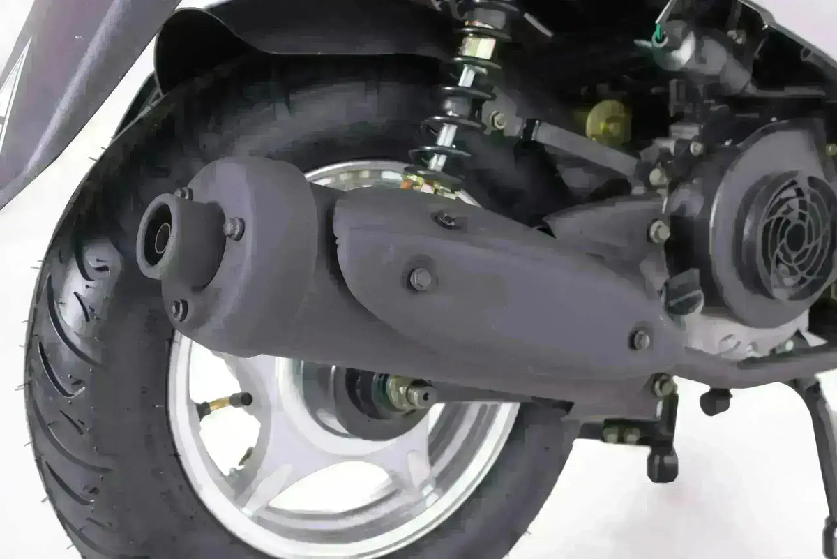 Close-up of scooter rear wheel, shock absorber, and exhaust pipe on white background