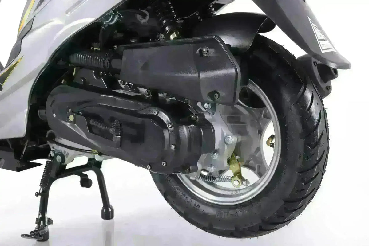 Close-up of scooter rear wheel, engine, and kickstand on white background