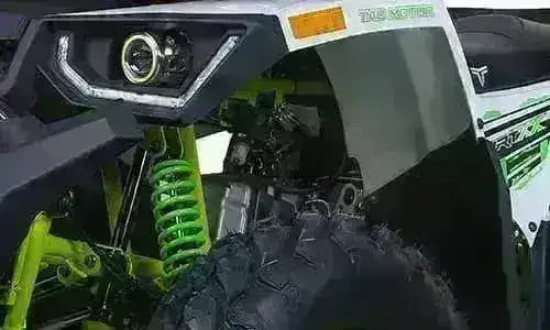 Front suspension and wheel of a utility four wheeler ATV with rugged tires and LED headlight