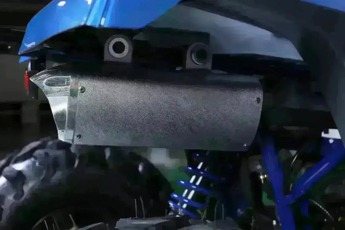 Close-up of rear suspension and exhaust on a utility ATV with off-road tire