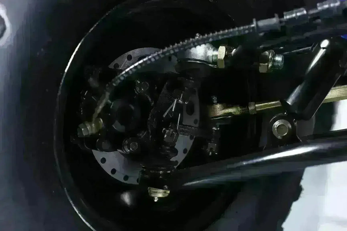 Close-up of utility ATV suspension and disc brake components
