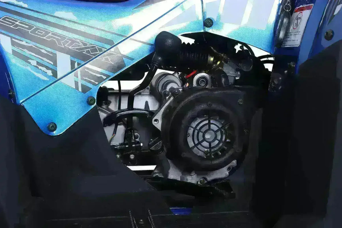 Close-up of a blue 200cc ATV engine and exhaust system under sport graphics panel