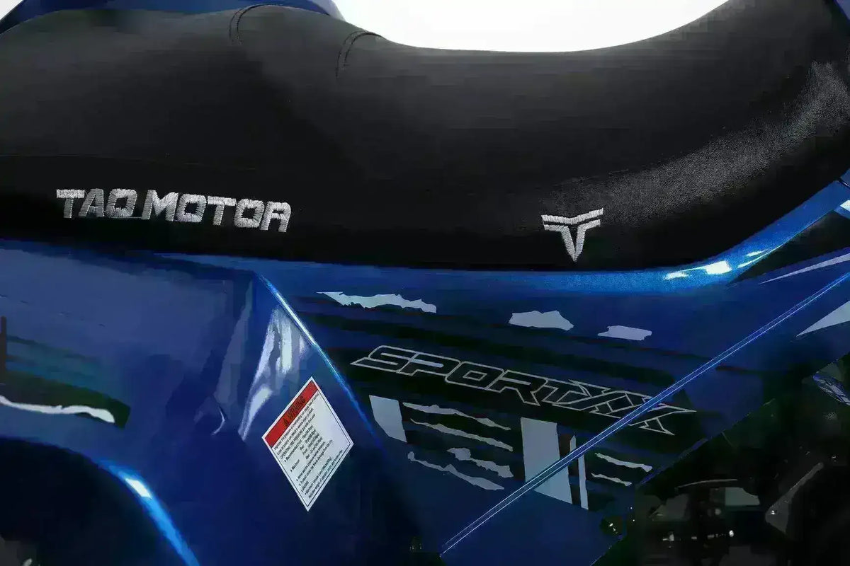Close-up of blue utility ATV seat with TAO Motor logo and Sportax decal