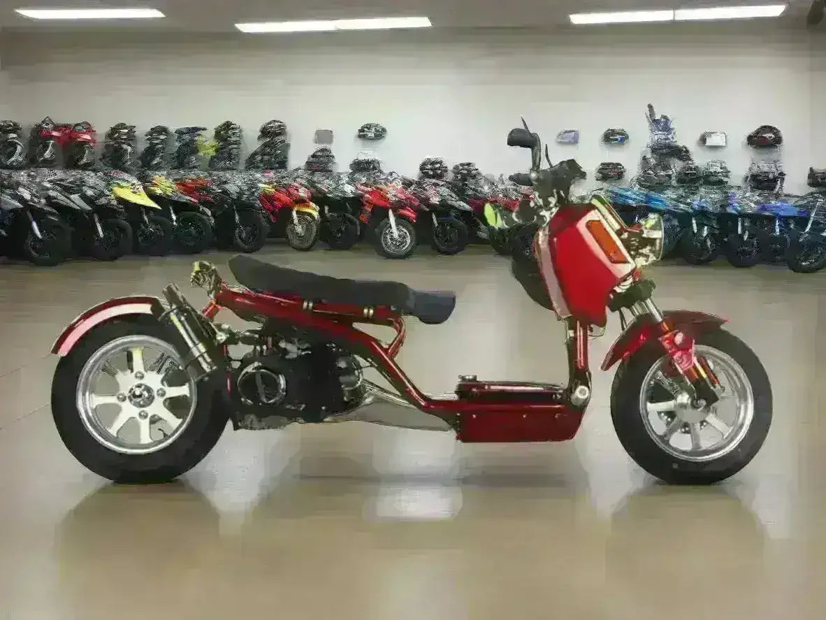 Red 150cc scooter with modern frame on showroom floor, motorcycles in background