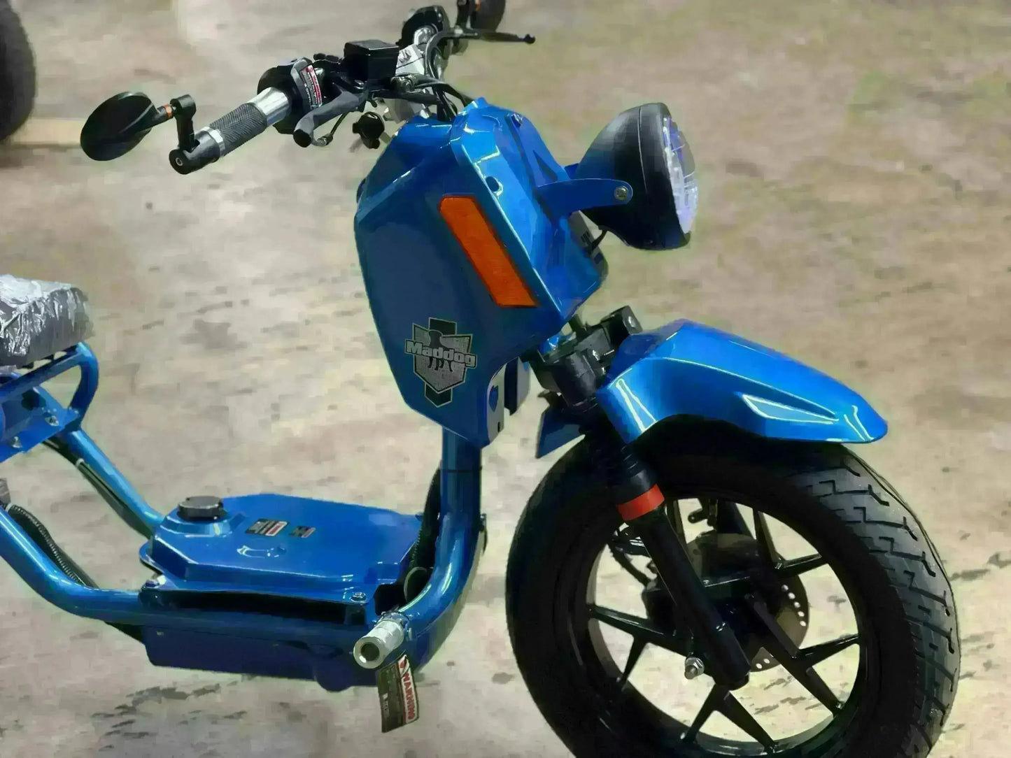 Blue Maddog 150cc scooter on showroom floor at Q9 PowerSports USA, youth vehicle display