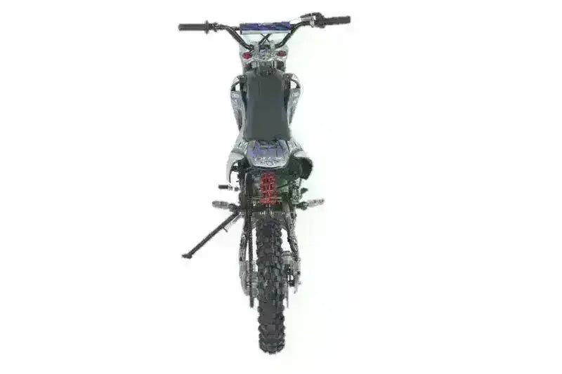 Rear view of a 125cc youth dirt bike with knobby tires and upright kickstand on white background.