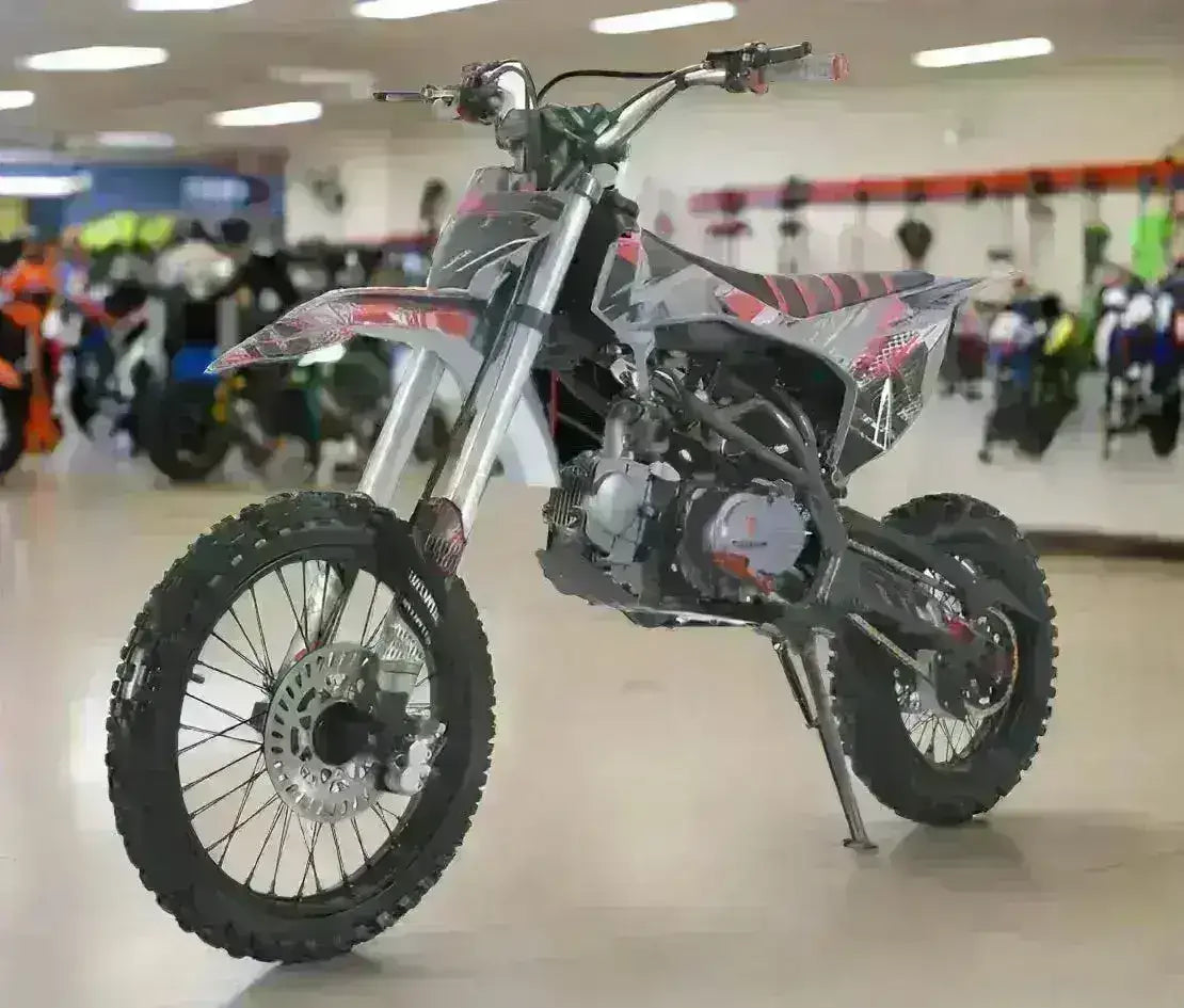 125cc youth dirt bike with rugged tires and sporty graphics on showroom floor