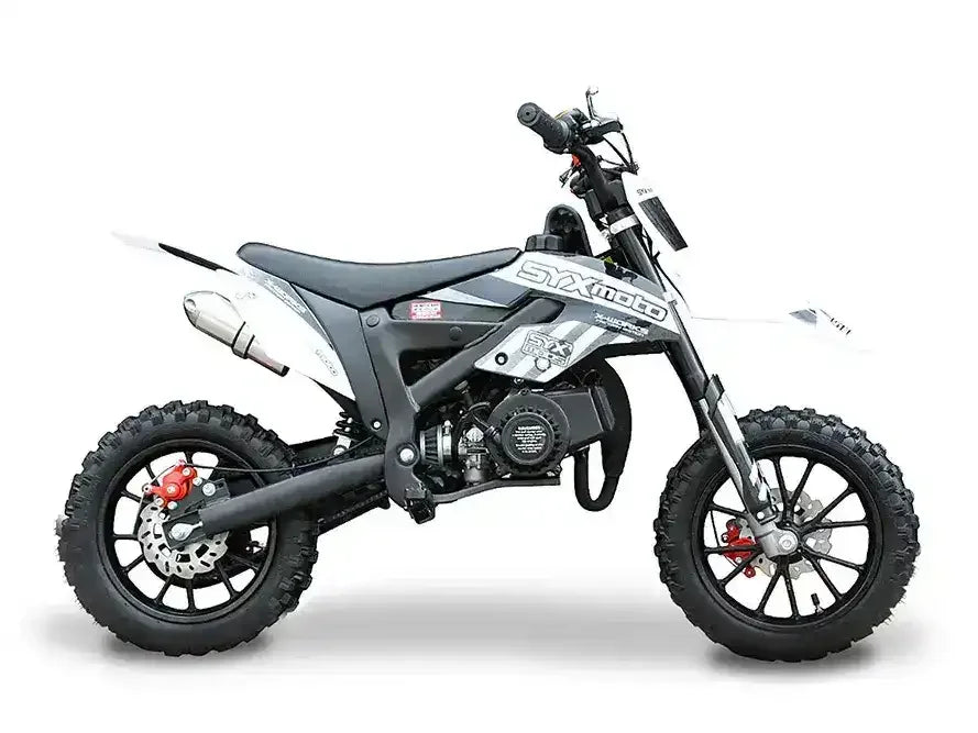 Black and white mini dirt bike with knobby tires and exposed engine on white background