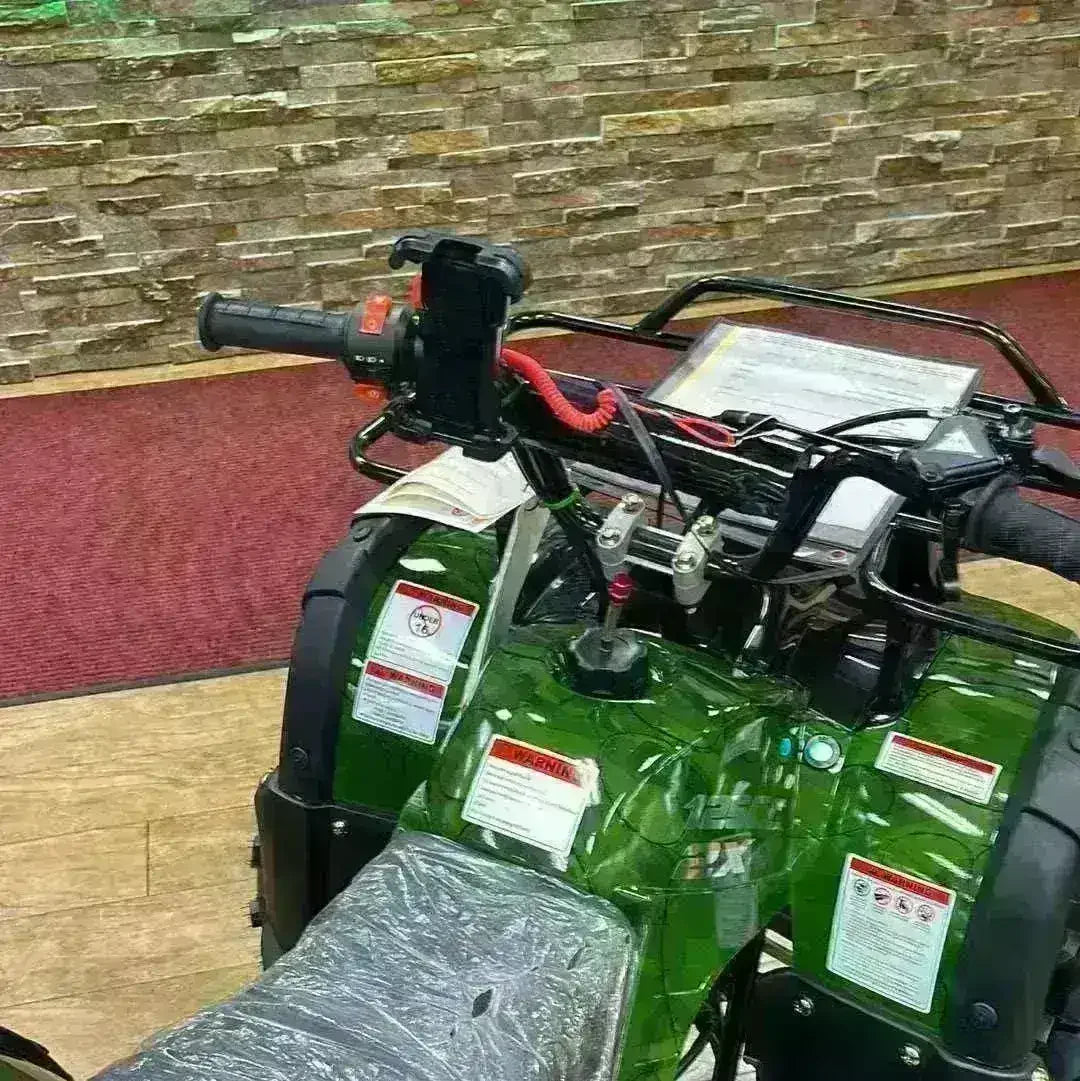 ATV handlebar with mounted cell phone holder on green four-wheeler, showroom setting