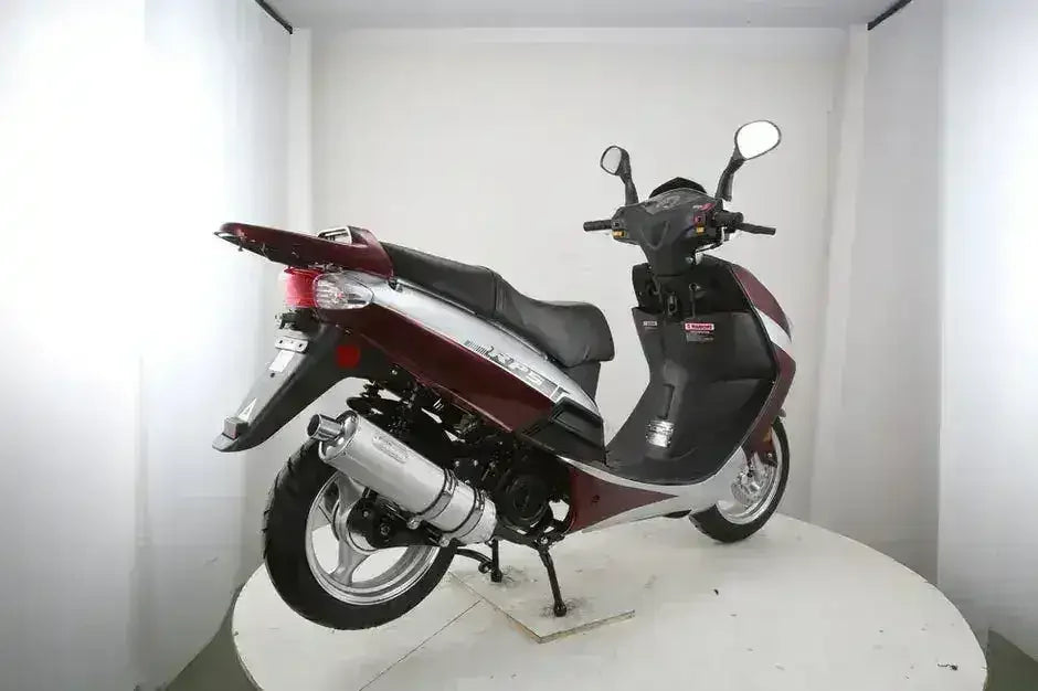 Burgundy and silver RPS Adventure motor scooter showing taillight, chrome exhaust and rear wheel, rear three-quarter view
