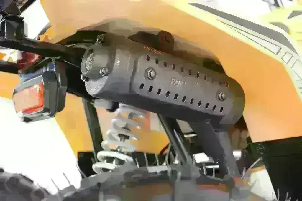 Close-up of rear suspension, exhaust, and taillight on yellow kids ATV