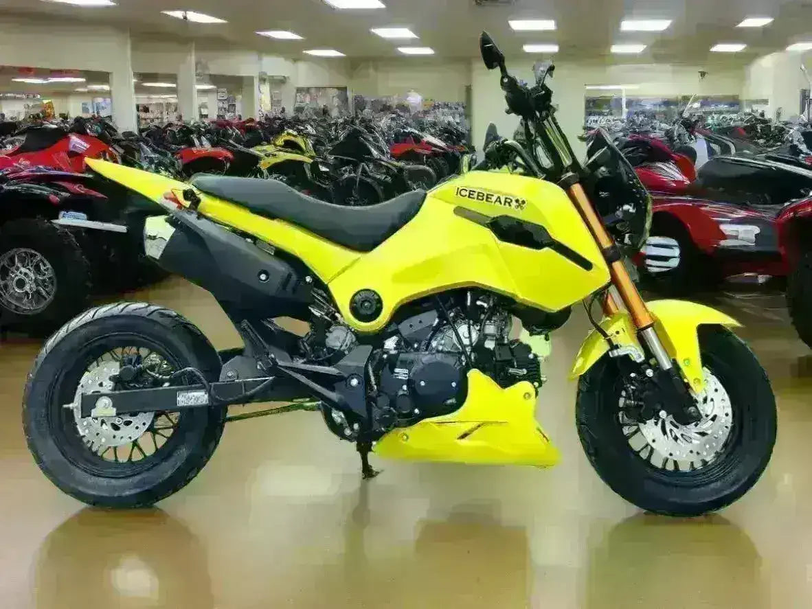 Yellow 125cc motorcycle with ICEBEAR logo in showroom, surrounded by ATVs
