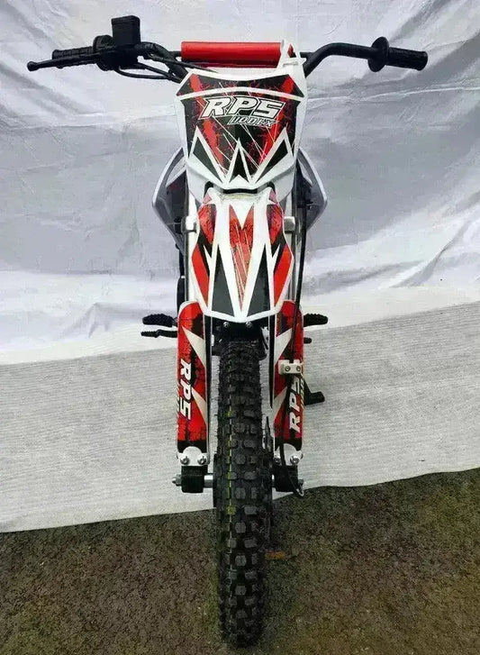 Front view of RPS 110cc dirt bike with red and white graphics and knobby tire