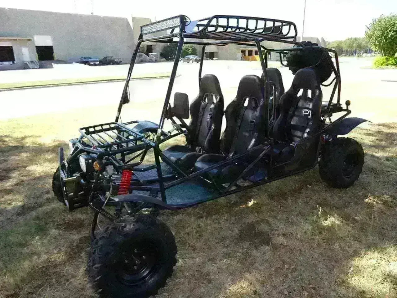 Four-seat 200cc go-kart with off-road tires and roll cage, parked on grass at Q9 PowerSports USA