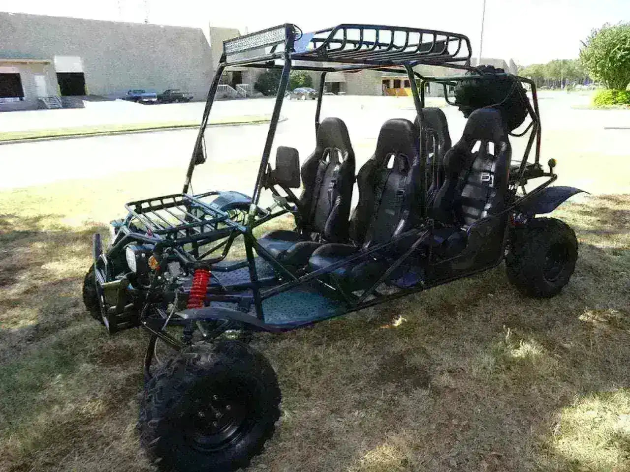 Four-seat 200cc go-kart with roll cage and off-road tires parked on grass