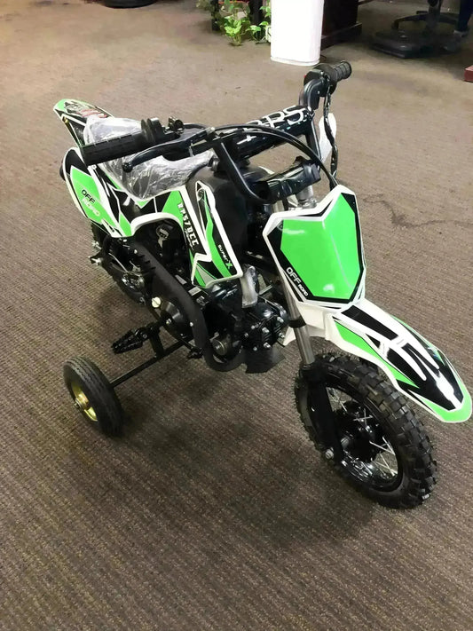 Green RPS 70cc kids dirt bike with training wheels, displayed indoors at Q9 PowerSports USA