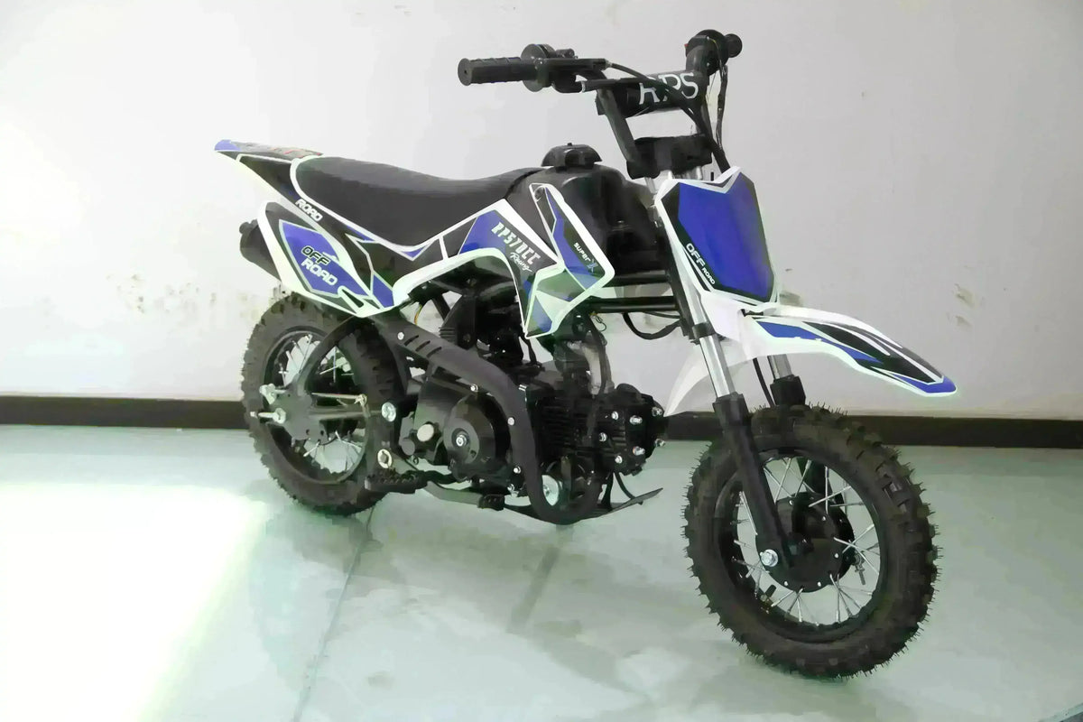 Blue and white 70cc kids dirt bike with knobby tires and training wheels in a showroom