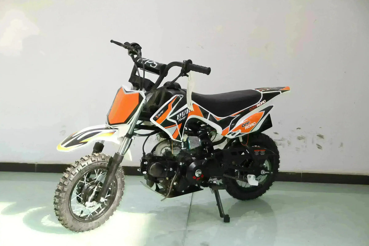 Small 70cc orange and black kids dirt bike with training wheels for beginners indoors