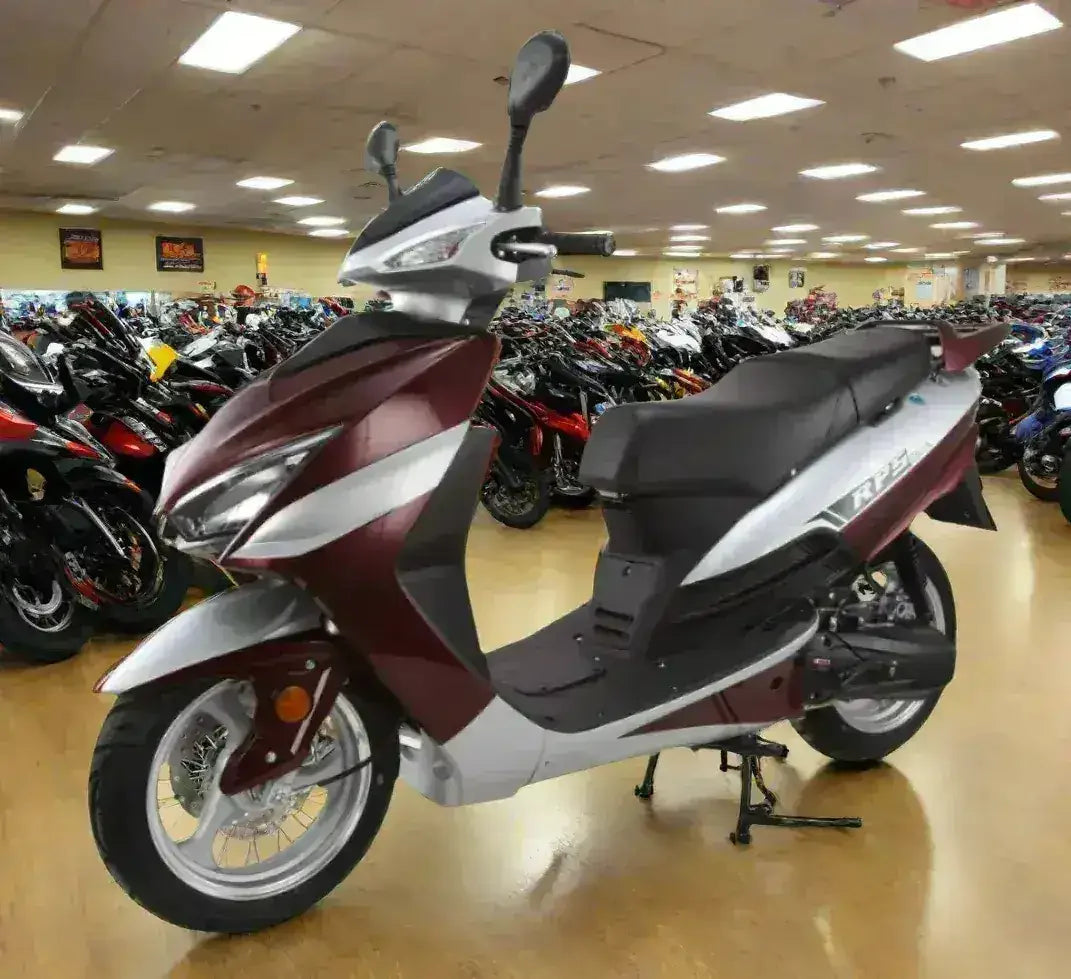 Burgundy and silver RPS Adventure motor scooter with black seat, front three-quarter view in the showroom
