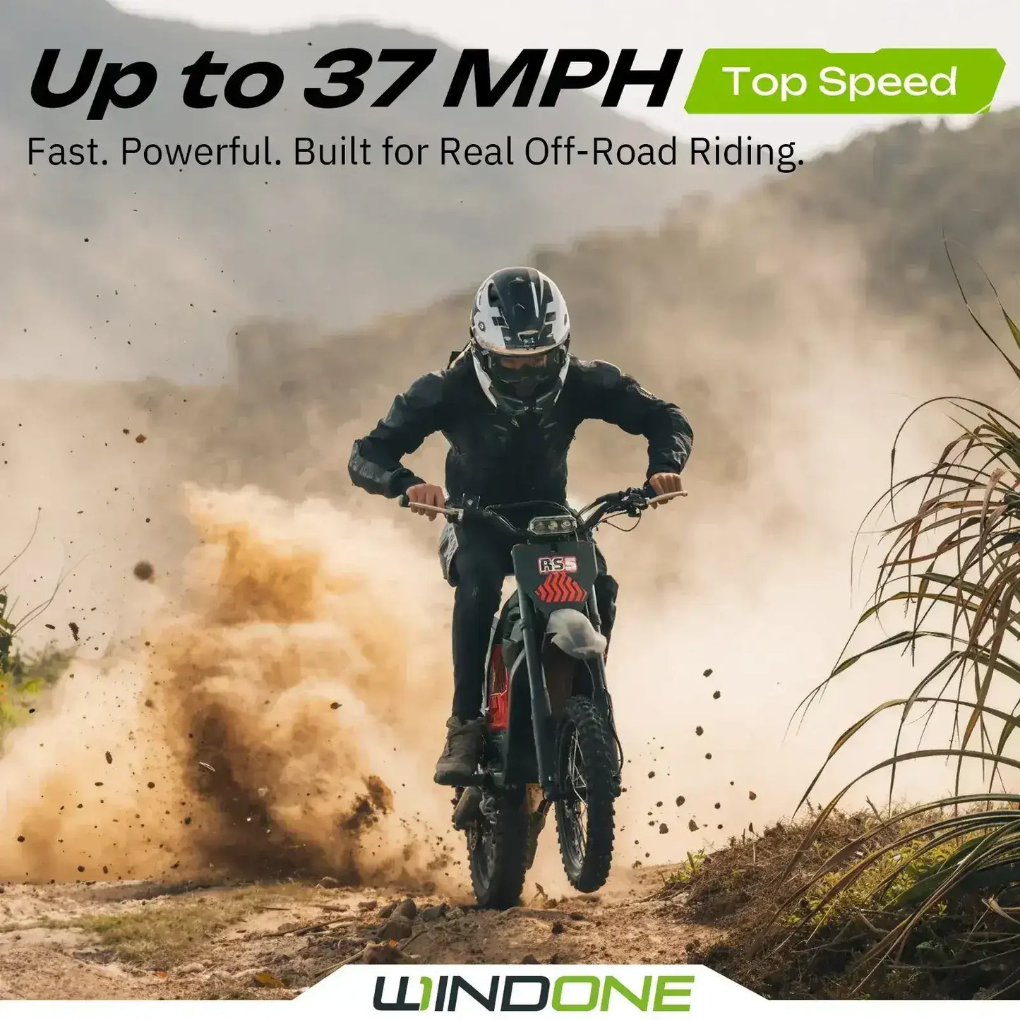 Rider on RS5 dirt bike speeding off-road, creating dust, with mountains in the background.