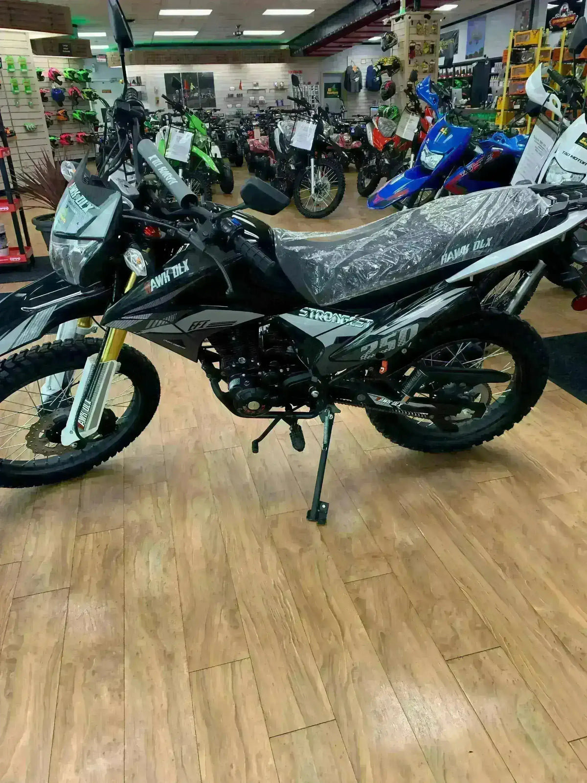 RPS Hawk DLX 250cc motorcycle on showroom floor, dual-sport dirt bike with knobby tires