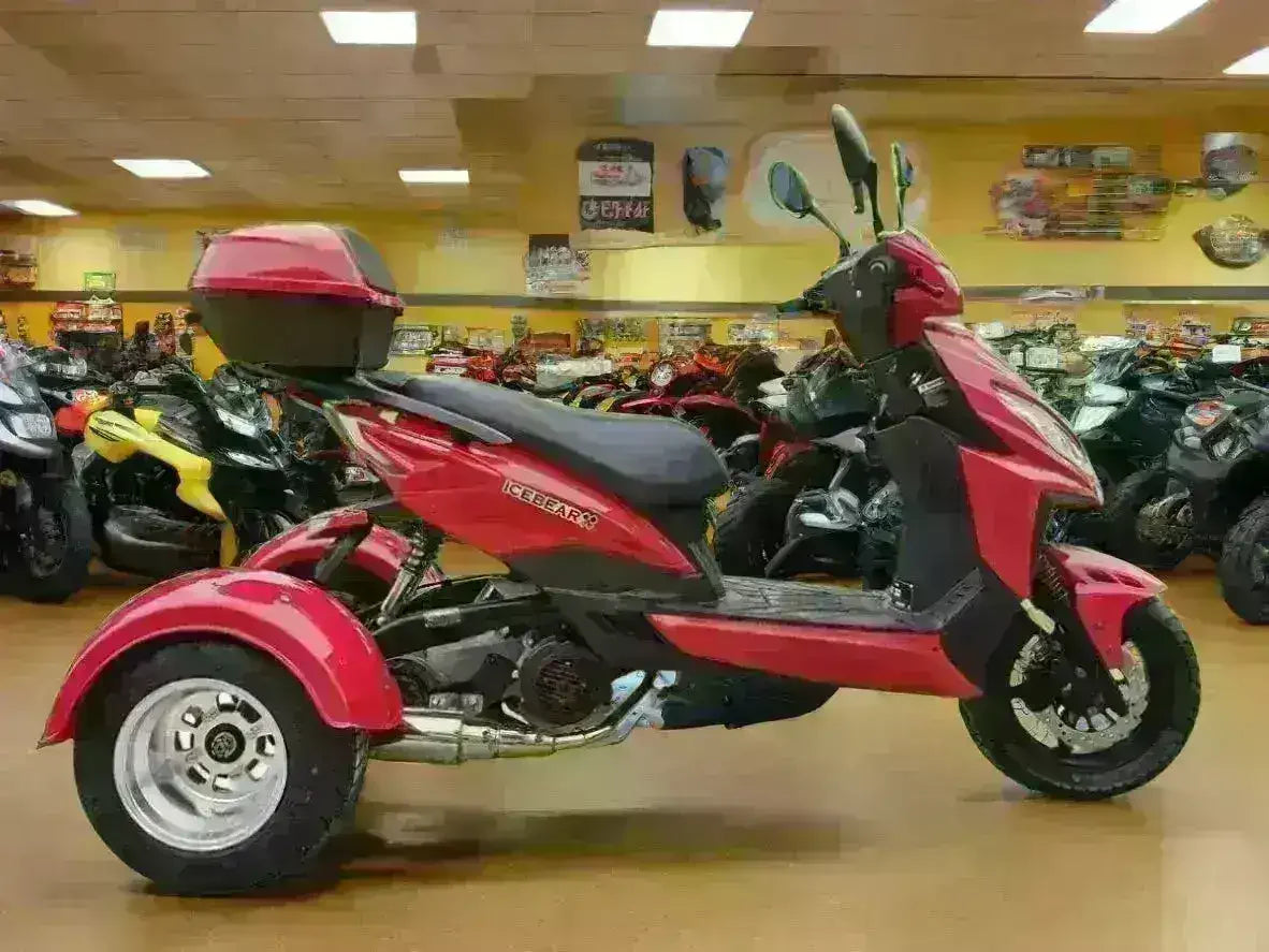 Red three-wheeled 150cc trike scooter with rear cargo box in a showroom