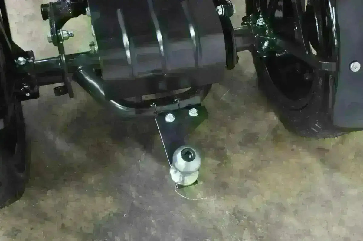 Rear hitch and axle of a three-wheeled 50cc trike scooter on garage floor