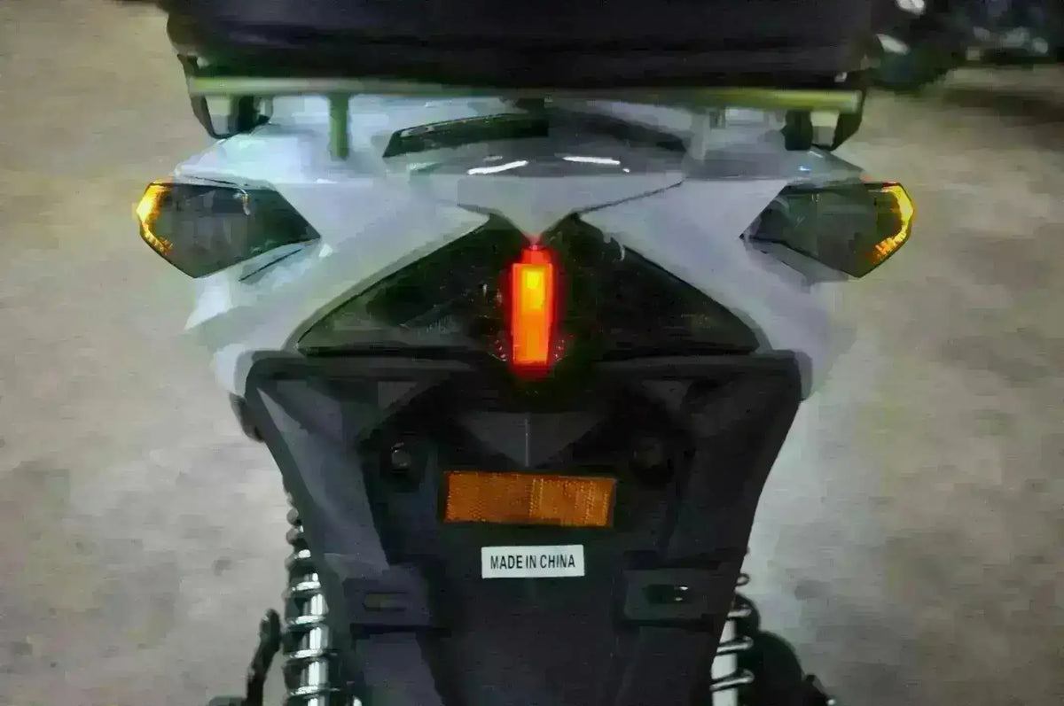 Rear view of three-wheeled 50cc trike scooter showing taillights and suspension.
