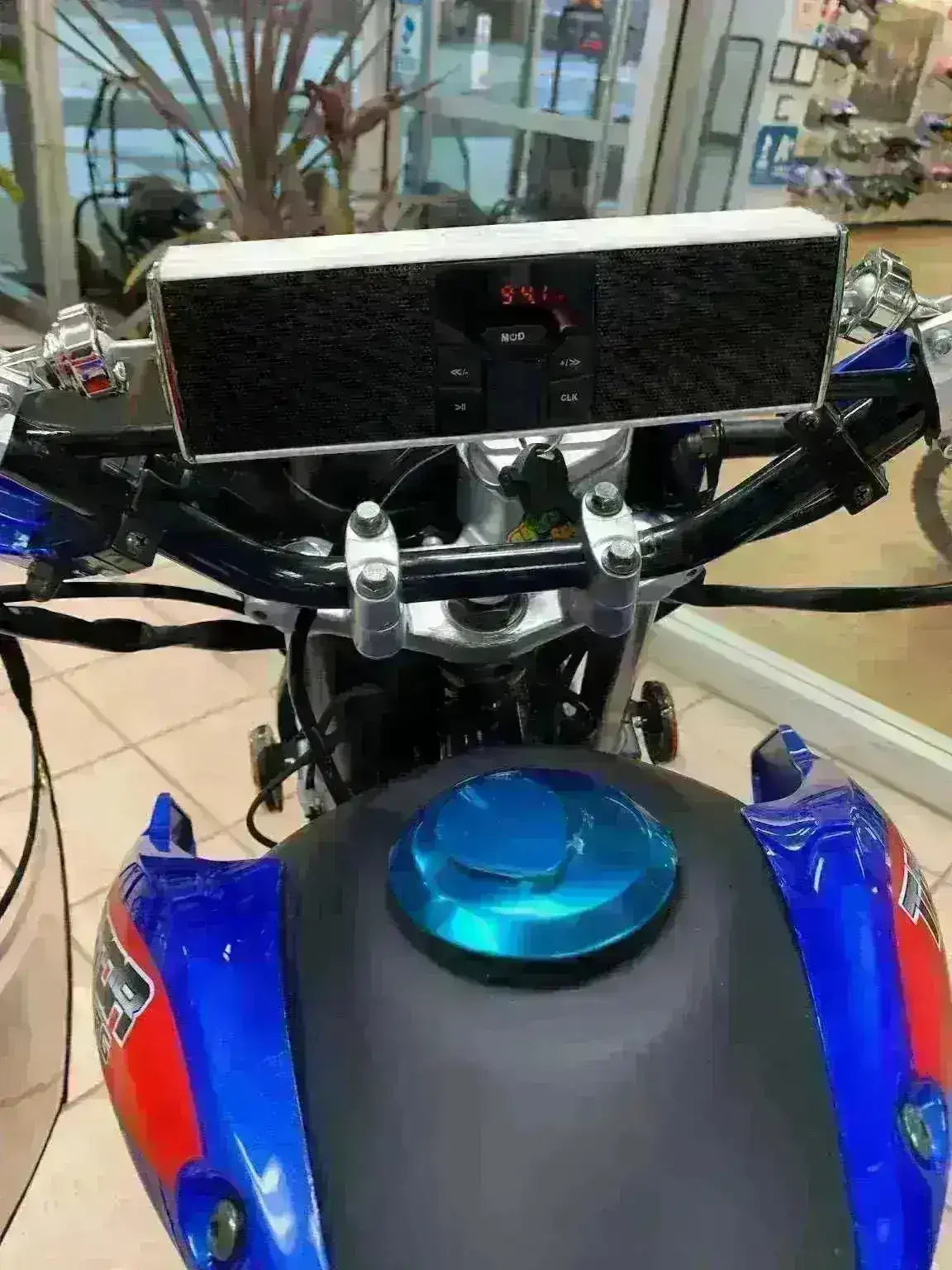 Universal mount Bluetooth speaker with radio installed on a motorcycle handlebar