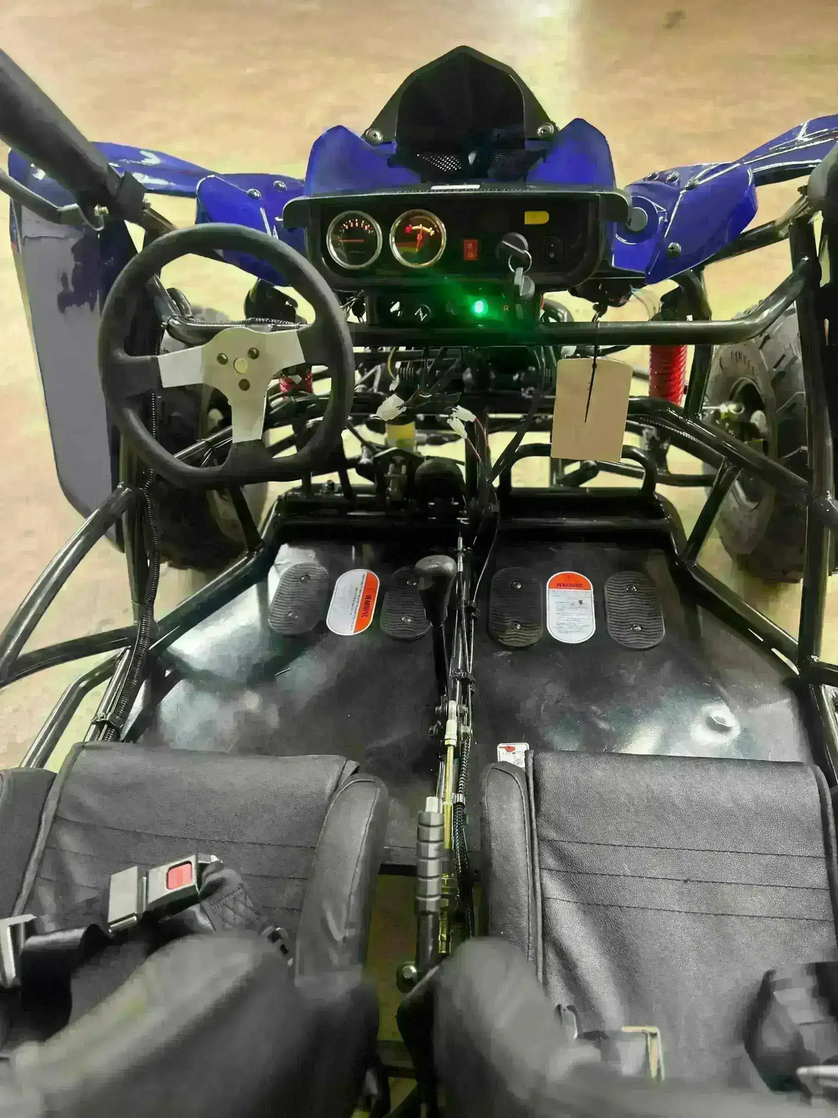 Dual seat 125cc go-kart interior with steering wheel, dashboard, and black seats