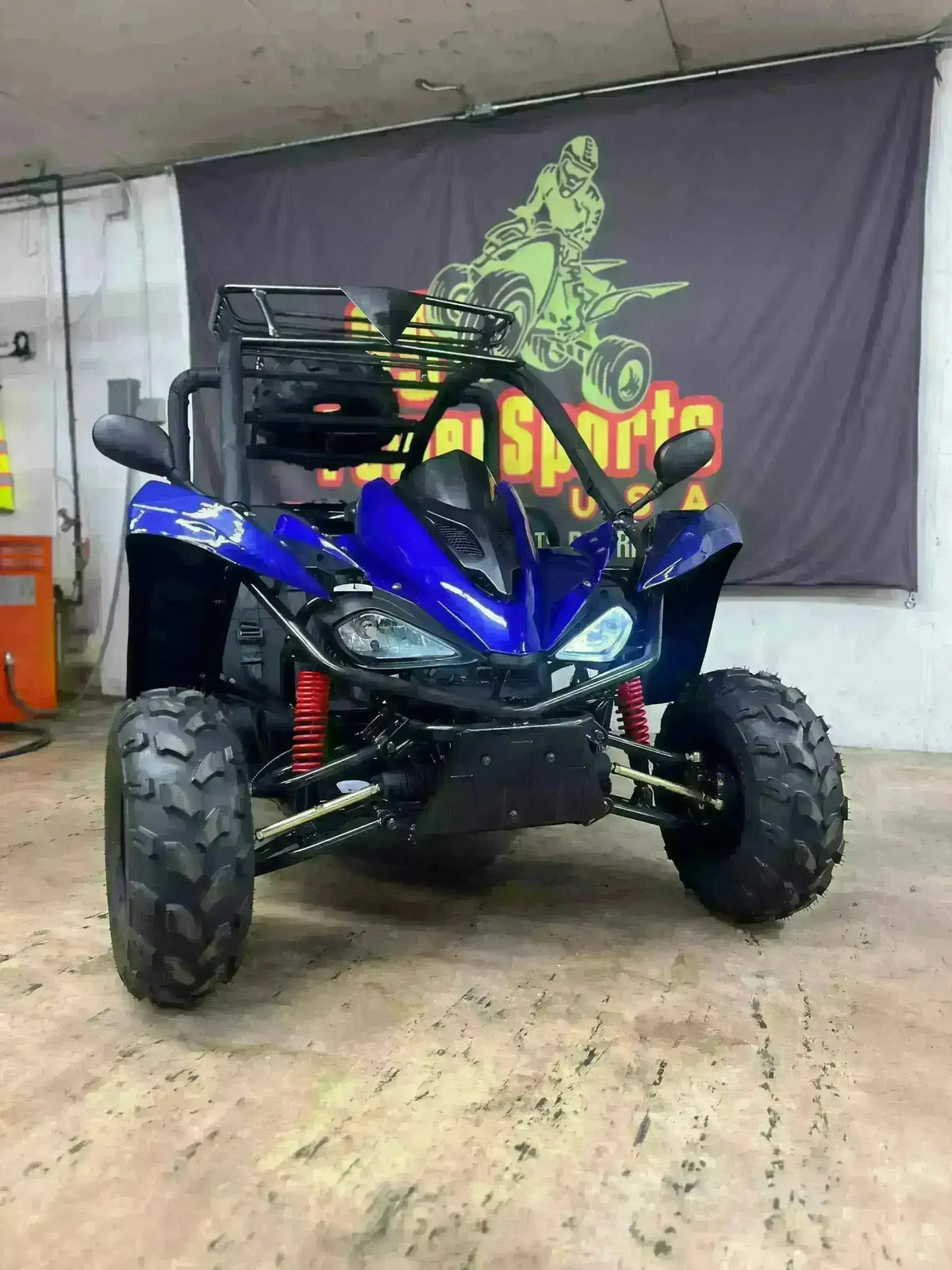 Blue 2-seater 125cc go-kart with off-road tires and roll cage in indoor showroom