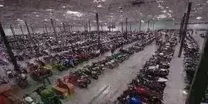 Large Q9 PowerSports USA warehouse storing rows of ATVs, four wheelers, and utility vehicles.