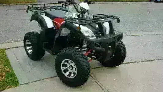 Black and white utility 200cc ATV four-wheeler with storage racks on pavement