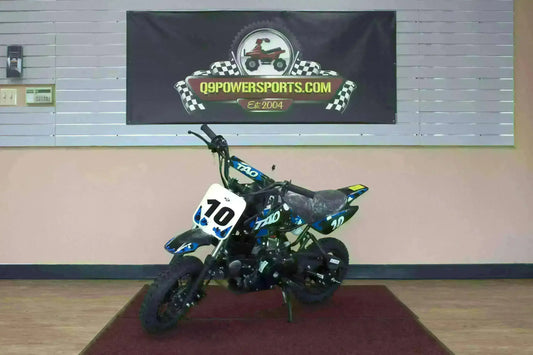 Blue 110cc kids dirt bike with number 10 plate, shown indoors on display carpet.